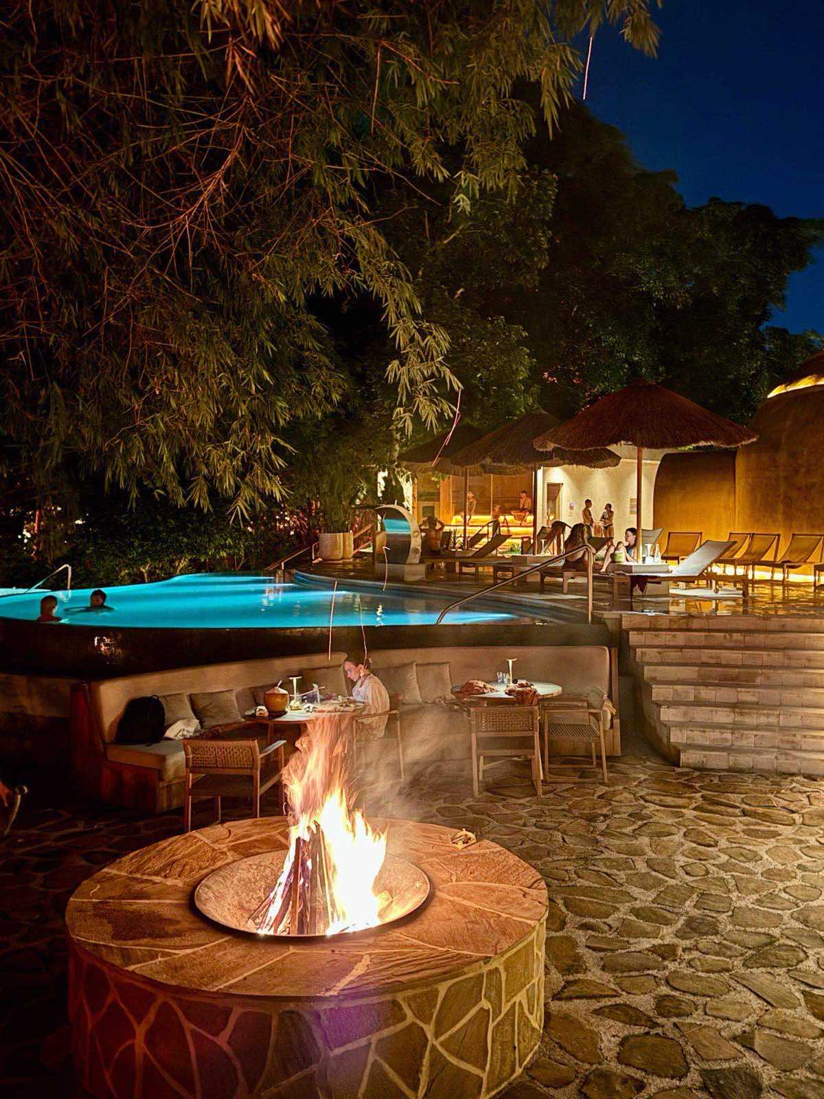 The fire pit by the pool after dark